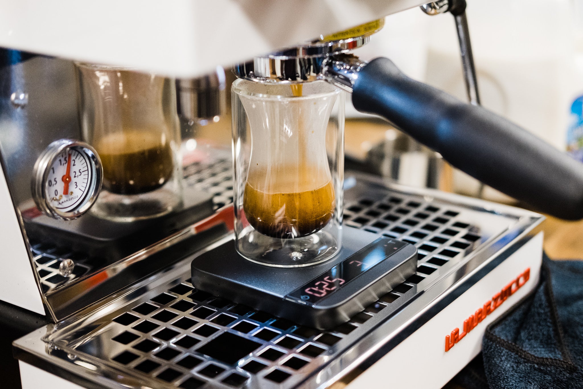 Espresso shot being served in glass shot