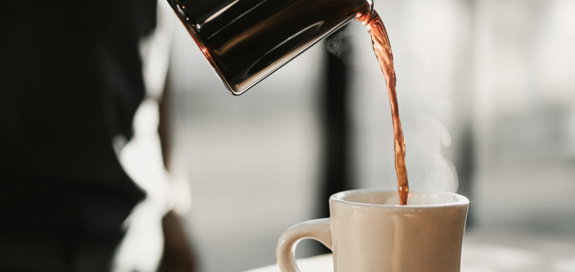 Pouring coffee into a cup